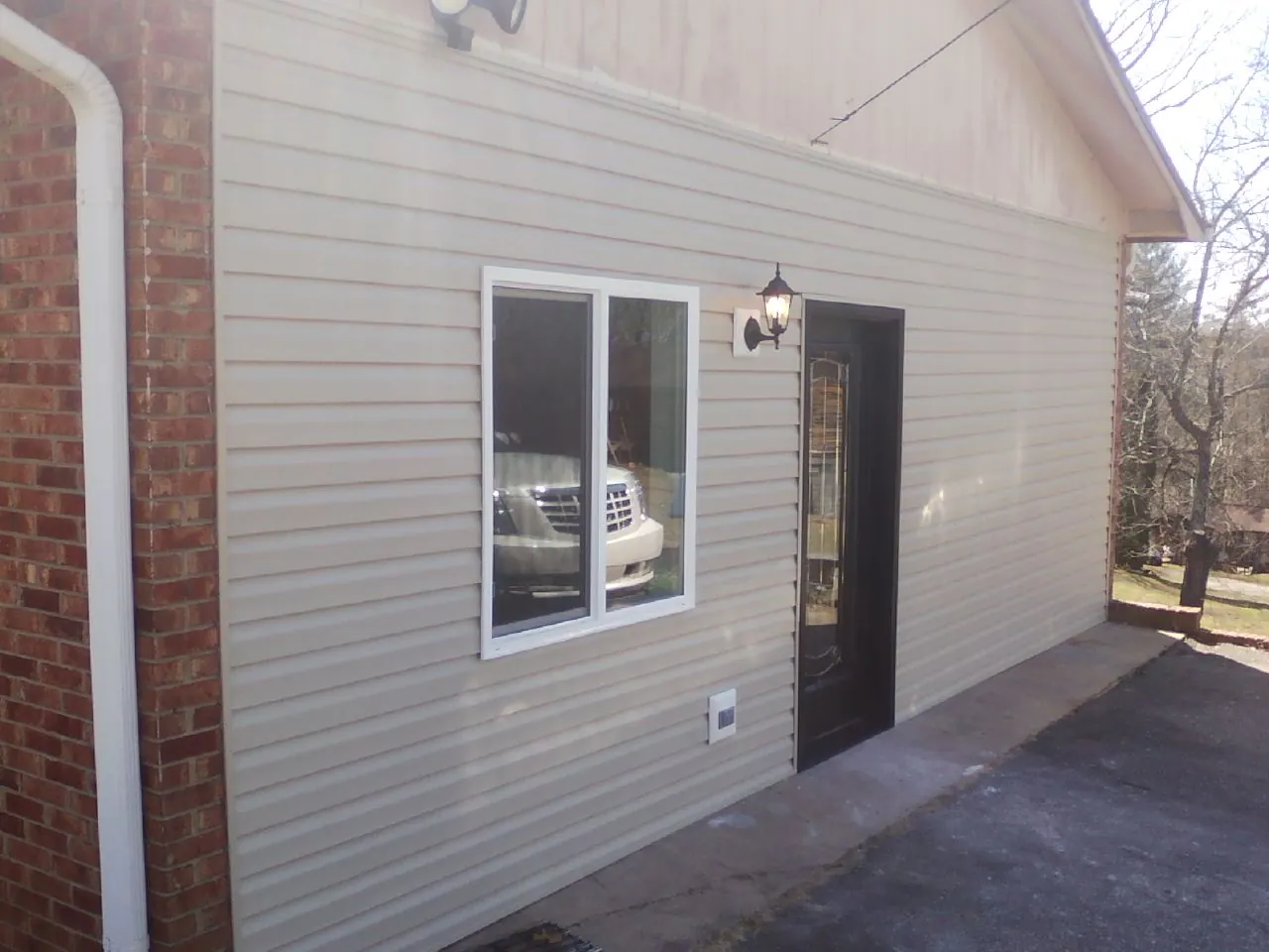 New vinyl siding and entry door on a room addition in Jacks Creek